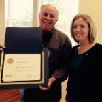 Heather receives a surprise Paul Harris Fellow honor, presented by Kevin.